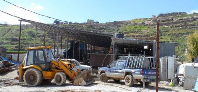 The Israeli occupation demolishes a water cistern and confiscates a caravan in Hebron