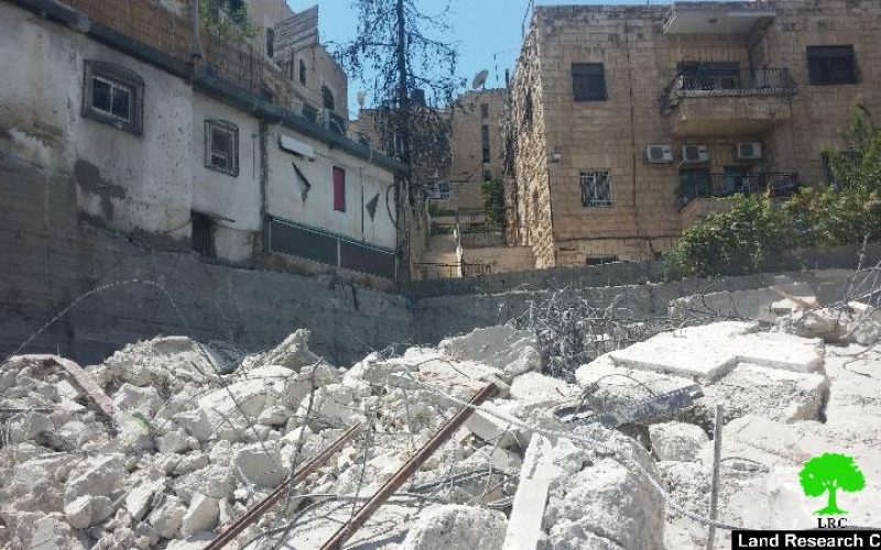 The Israeli occupation municipality demolishes a three story building in the Jerusalem neighborhood of Wad Al-Juz