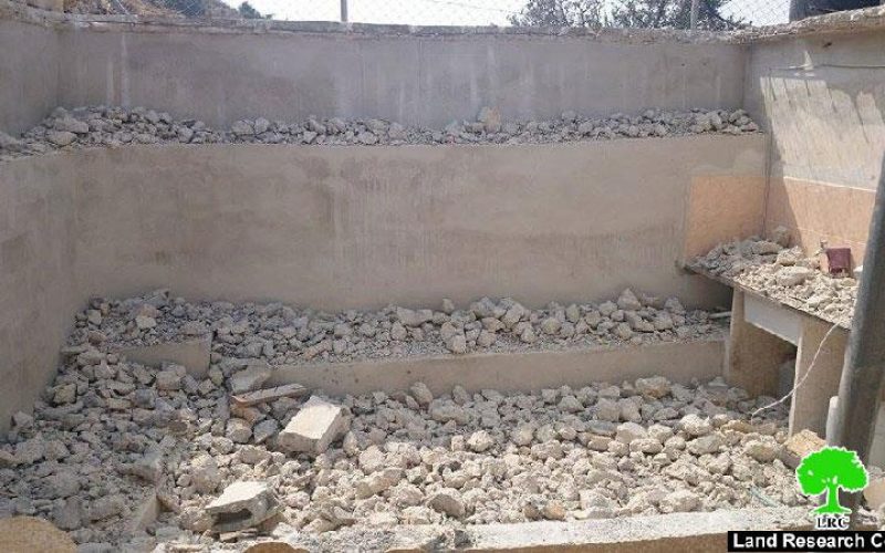 Self-demolition: A crime against humanity<br> 
The Israeli occupation forces a Palestinian to self-demolish his agricultural room in the Hebron village of Beit Kahil