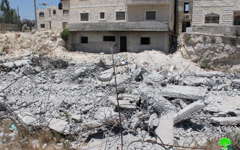 Dozers of Israeli municipality in Jerusalem demolish a house in the Al-Isawiya town