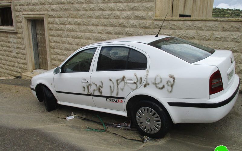 Israeli colonists paint Anti-Arab graffiti on several cars in Jit village in the West Bank.