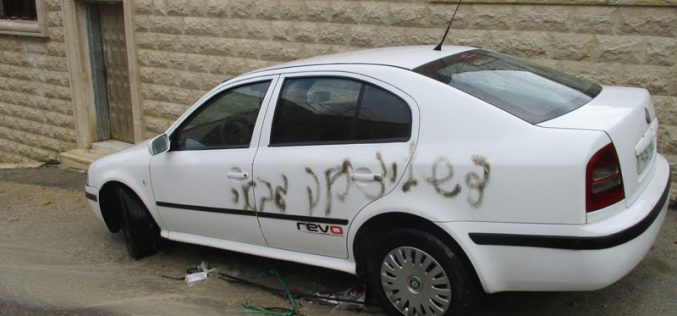 Israeli colonists paint Anti-Arab graffiti on several cars in Jit village in the West Bank.
