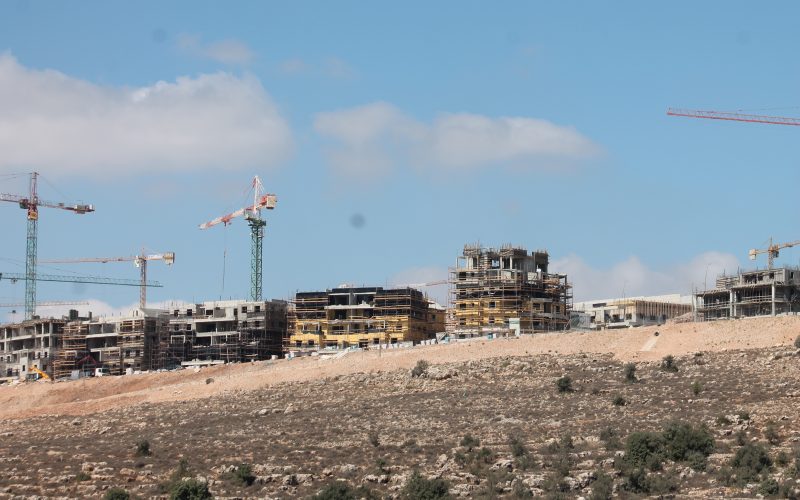 What is the impact of Israeli land policies and the settlement industry in the West Bank?
