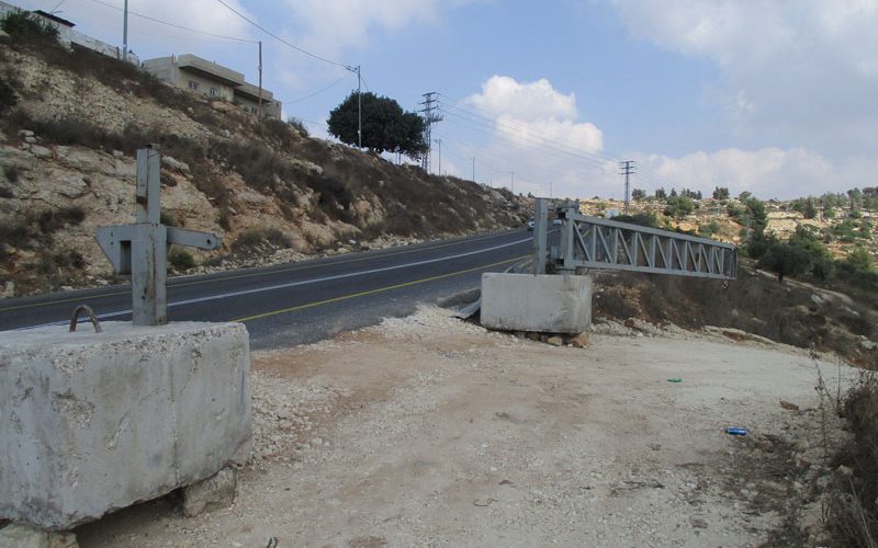 Setting up a metal gate and halting work on an agricultural road in Umm Safa/ Ramallah governorate