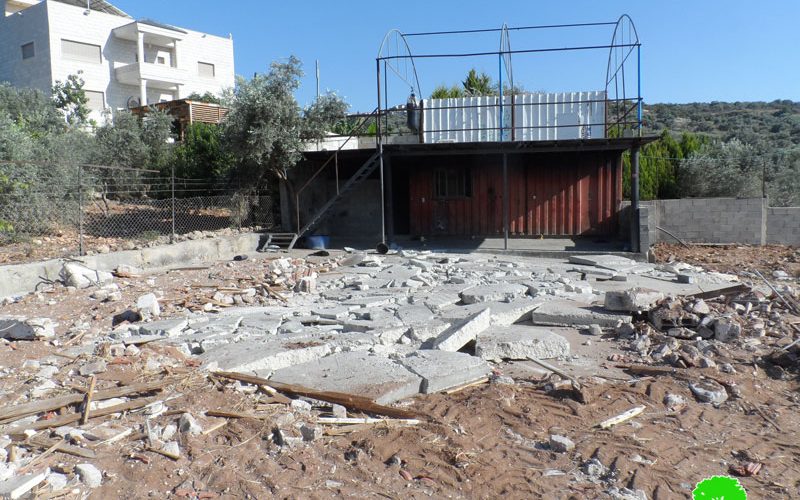 The occupation forces a citizen to demolish a car washroom he owns in “Al-Nabi Elias” in Qalqilya Governorate