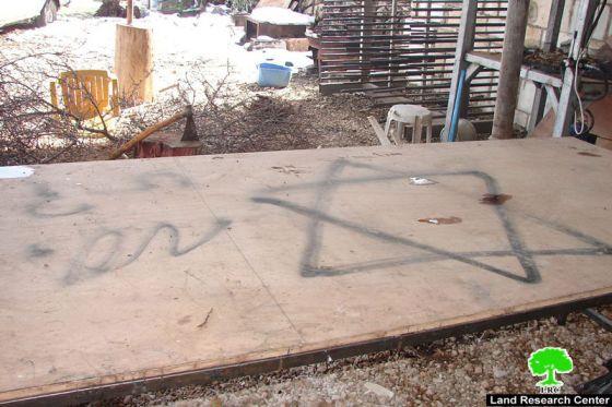 مستعمرون يحرقون سيارة ويخطون شعارات في “خلة الشبك ” شرق بيت أمر”