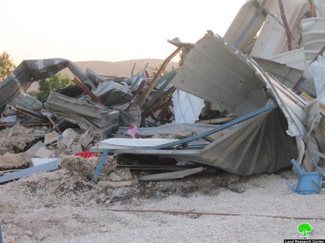 Demolishing a commercial structure in Sabastiya