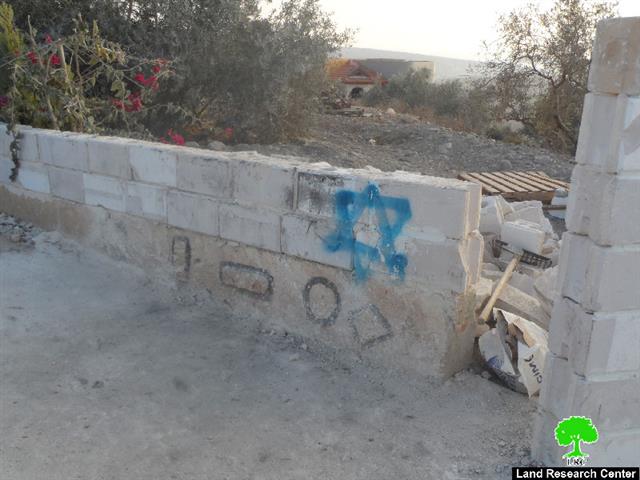 Torching two vehicles and drawing ” hatred inciting ” slogans in Faraata