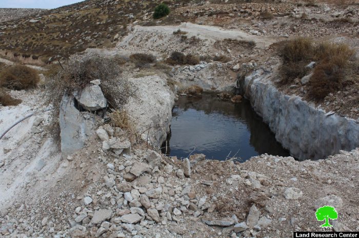 Ravaging 10 dunums, uprooting trees and demolishing water pool in Hebron town of Dura