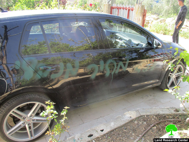 Israeli colonists write racist graffiti and slash cars’ tires in Qalqiliya