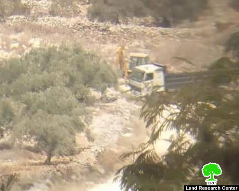 Confiscating a bulldozer and a truck in Kafr Qadoum village/ Qalqilya governorate